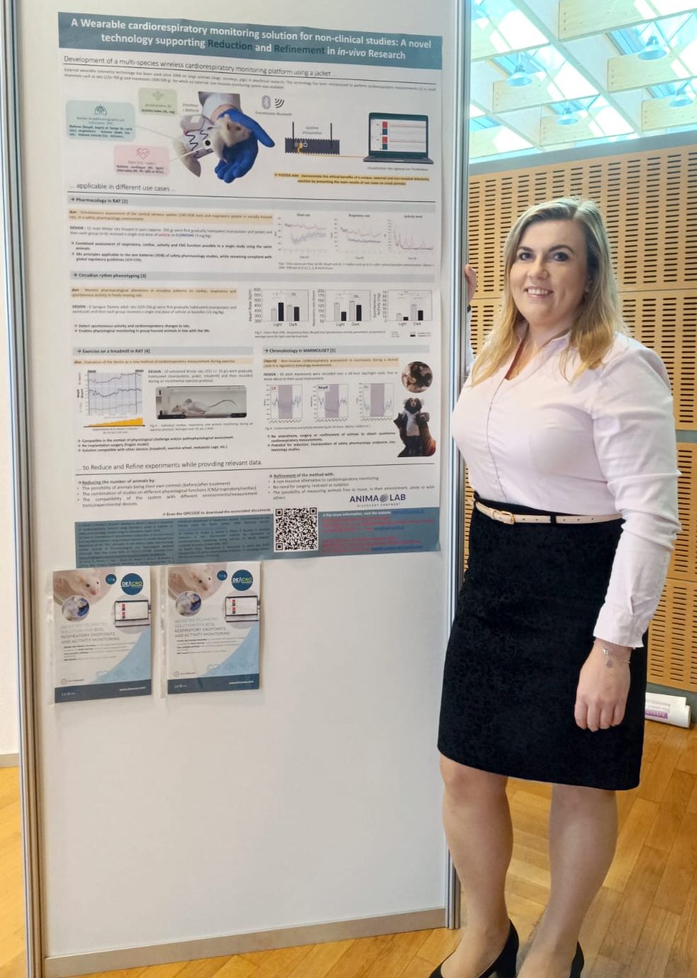 Monika Wozniak in from of the DECRO Jacket poster CEBS Congress, Poland